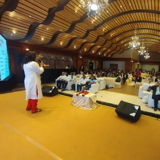 Rupali Shevade speaking at a professional health seminar in Pune